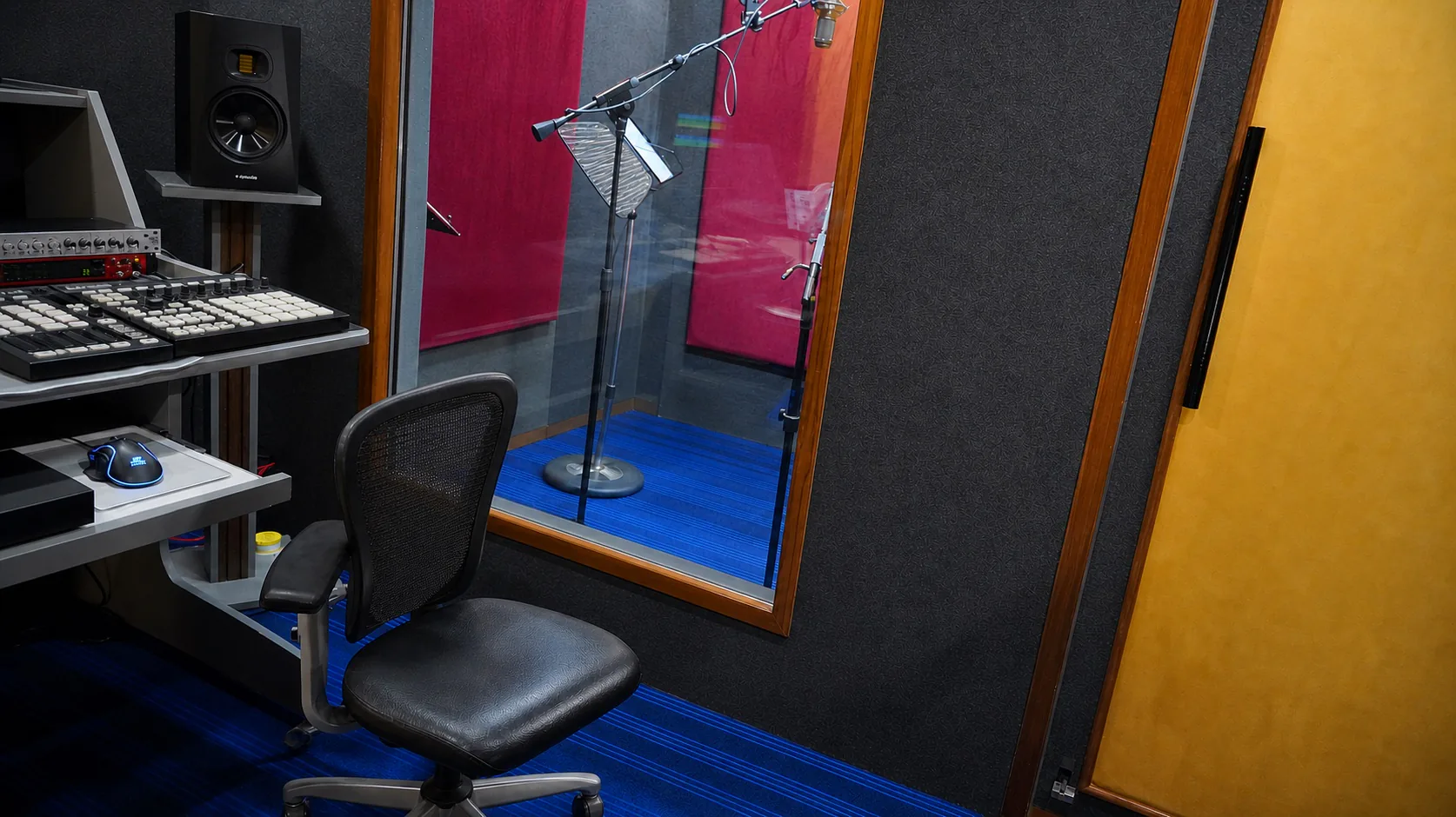 Enhanced empty CloudStudio108 console area overlooking the treated vocal booth