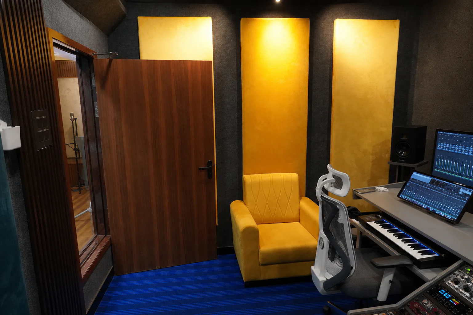 Empty CloudStudio108 control room with production desk, keyboard, monitors, and audio hardware