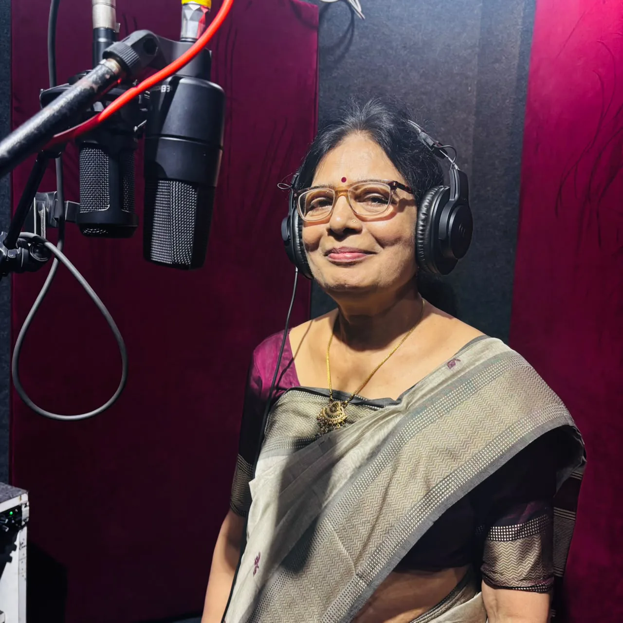 Female vocalist wearing headphones beside the CloudStudio108 microphones