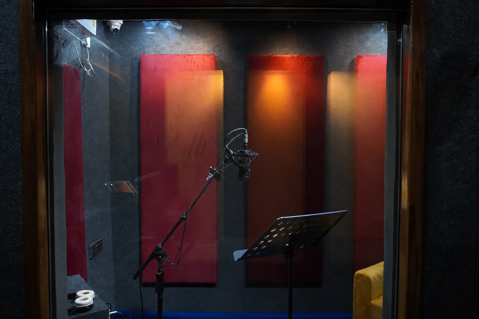 Empty treated vocal booth viewed through the CloudStudio108 control-room window
