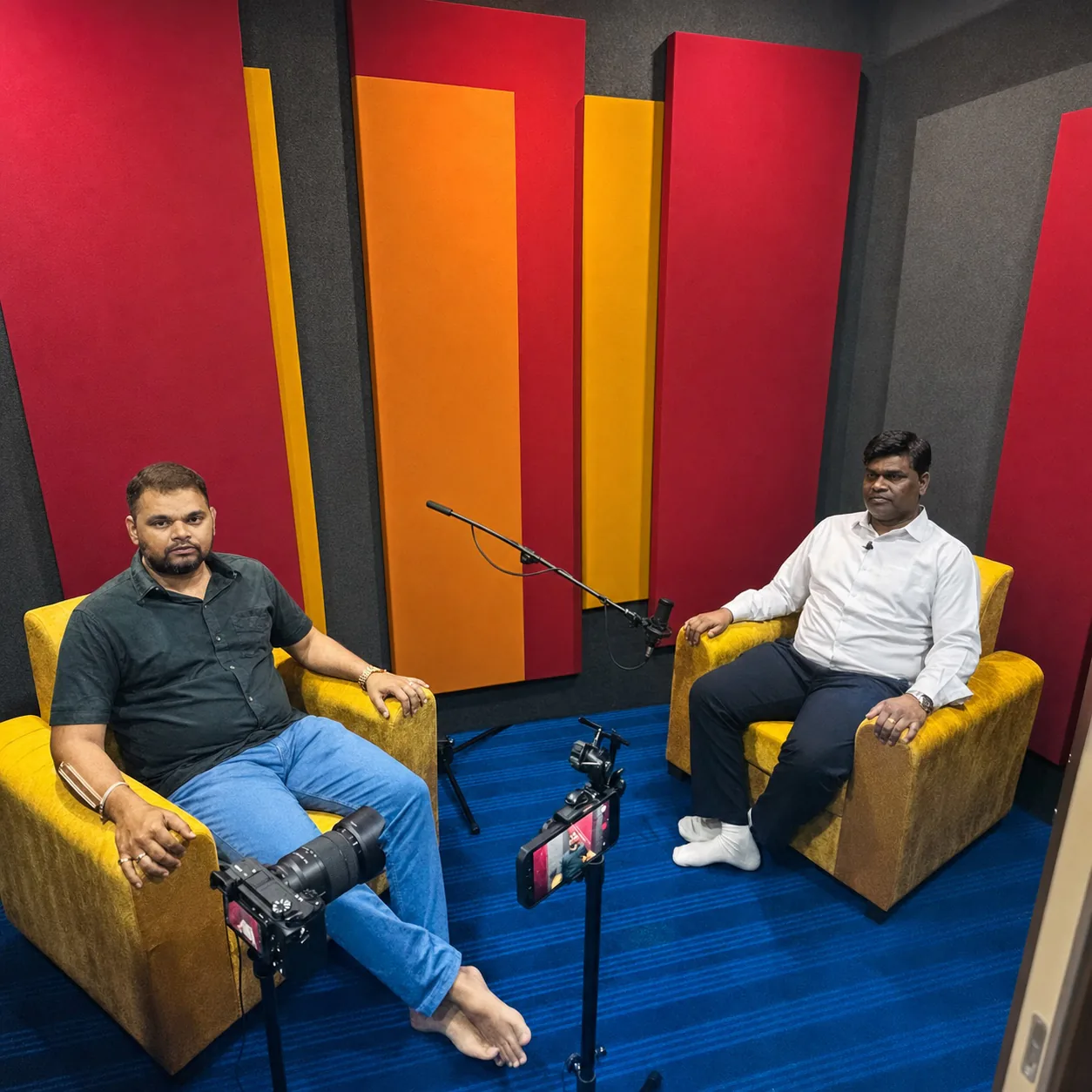 Two clients seated in the spacious CloudStudio108 recording room during a filmed conversation